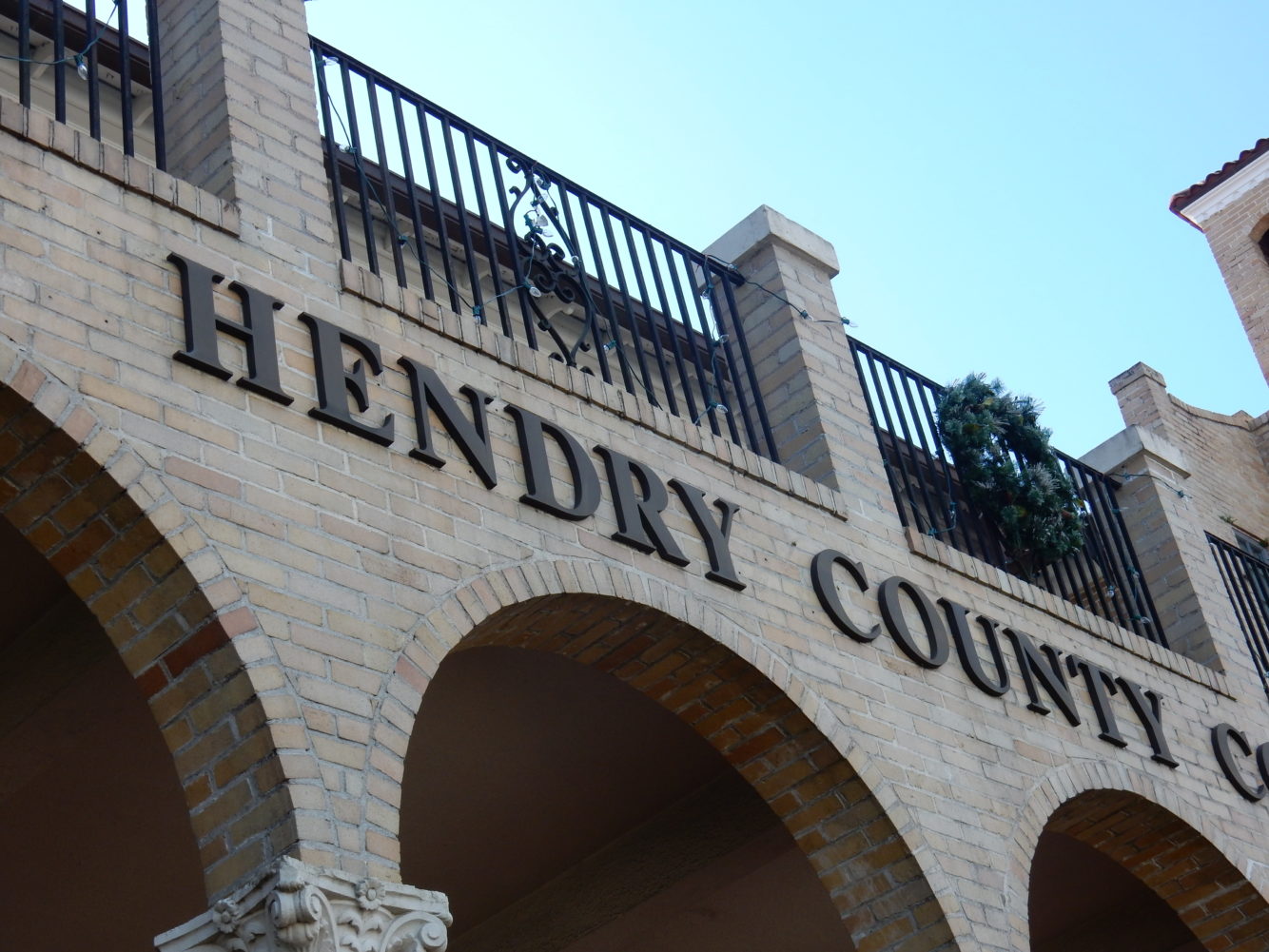 A closeup of the hendry county court building signage on the front of the building