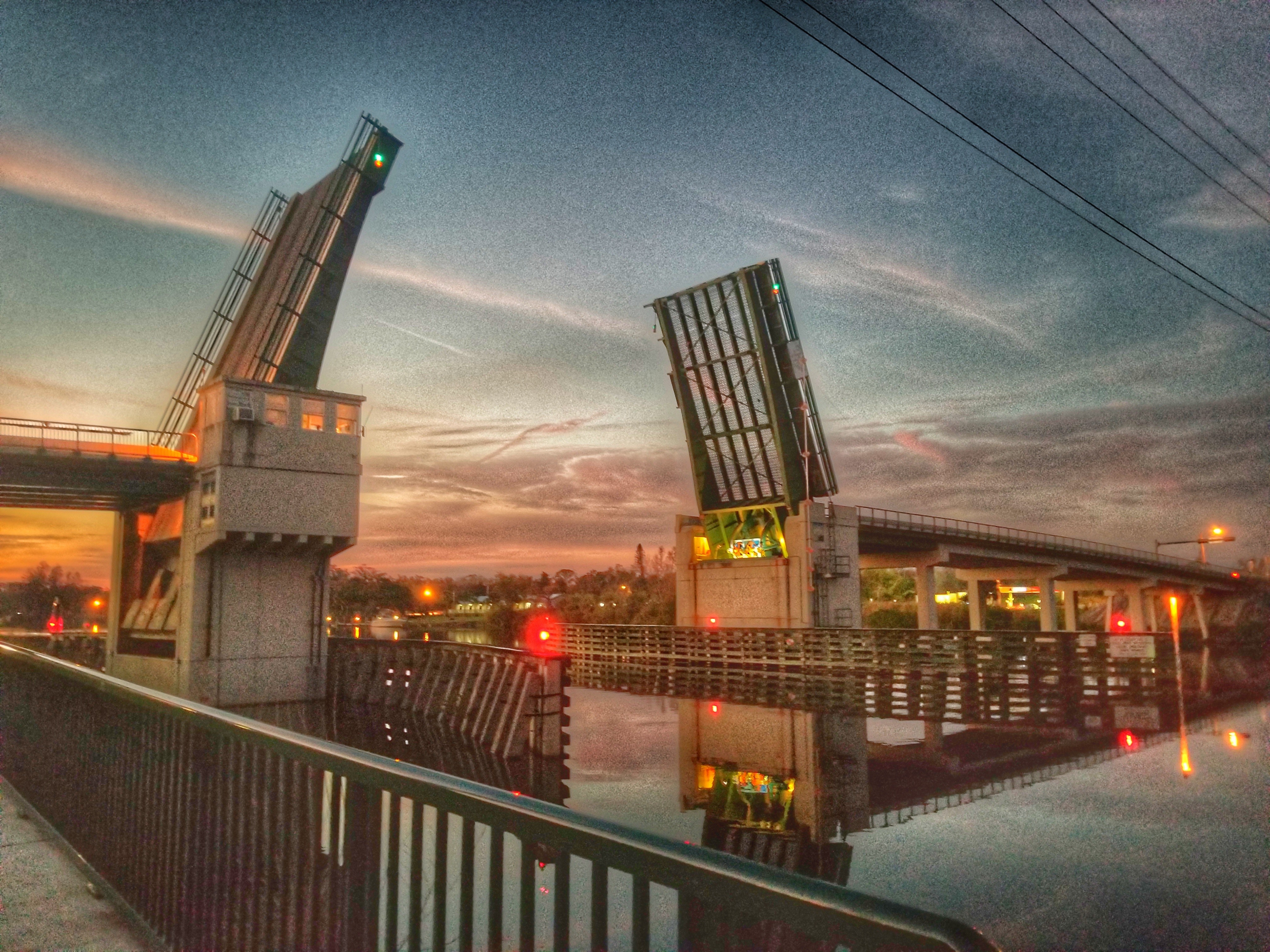 A drawbridge over the canal. The bridge is currently up.